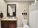 Classic bathroom with dark wood vanity, granite countertop, and ample storage at 5521 Salem N Dr, Carmel, IN 46033