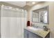 Tastefully designed bathroom with a marble countertop, and a white shower curtain at 5521 Salem N Dr, Carmel, IN 46033