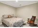 Cozy bedroom with a queen-size bed and a rocking chair at 5521 Salem N Dr, Carmel, IN 46033