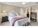 Relaxing bedroom featuring a comfortable bed and a view to the ensuite bathroom at 5521 Salem N Dr, Carmel, IN 46033