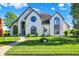 Beautiful two-story home with manicured lawn, unique architectural details, and a welcoming facade at 5521 Salem N Dr, Carmel, IN 46033