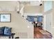 Inviting foyer showcasing hardwood floors and staircase, leading into the dining room at 5521 Salem N Dr, Carmel, IN 46033
