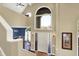 Inviting foyer with a view into the dining room, featuring a front door with glass panels at 5521 Salem N Dr, Carmel, IN 46033