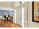 Open foyer with hardwood floors and natural light, leading to dining area with elegant chandelier at 5521 Salem N Dr, Carmel, IN 46033
