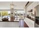 This open kitchen features an island with granite counters and provides tranquil views of the nearby lake at 5521 Salem N Dr, Carmel, IN 46033