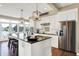 Modern kitchen with stainless steel appliances, granite counters, and large windows overlooking a serene lake at 5521 Salem N Dr, Carmel, IN 46033