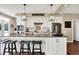 Bright kitchen with granite countertop island, modern lighting, and stainless-steel appliances offers open and stylish design at 5521 Salem N Dr, Carmel, IN 46033