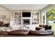Beautiful living room with fireplace, built-in shelving, and large windows providing natural light and lake views at 5521 Salem N Dr, Carmel, IN 46033