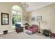 Bright and airy living room with tall windows, soft carpet, and comfortable seating arrangements at 5521 Salem N Dr, Carmel, IN 46033