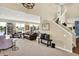 Inviting living room features large windows with lake views and a staircase to the second floor at 5521 Salem N Dr, Carmel, IN 46033
