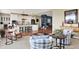 Open-concept living room with stylish furniture, flowing to a bright kitchen with barstool seating and decor at 5521 Salem N Dr, Carmel, IN 46033