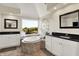 Bright main bathroom features white cabinets, dark countertops, a garden tub, and a large window with a scenic view at 5521 Salem N Dr, Carmel, IN 46033