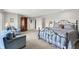 Comfortable sitting area in the spacious main bedroom with an iron bed frame and neutral colored decor at 5521 Salem N Dr, Carmel, IN 46033