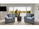 Relaxing sitting area with lake views, armchairs, and a central table in main bedroom at 5521 Salem N Dr, Carmel, IN 46033