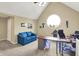 Bright office space with a round window, blue couch, and functional desk setup at 5521 Salem N Dr, Carmel, IN 46033