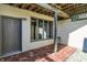 Brick patio featuring an exterior door, window, and privacy screening under wood framing at 5521 Salem N Dr, Carmel, IN 46033