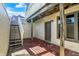 Brick patio with stairs leading to a balcony, plus a convenient door and windows at 5521 Salem N Dr, Carmel, IN 46033