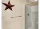 Bright shower with glass doors and decorative star at 5521 Salem N Dr, Carmel, IN 46033