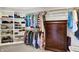 Walk-in closet with built-in shelving, hanging rods, and a wooden dresser for organized storage at 5521 Salem N Dr, Carmel, IN 46033
