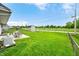 Spacious backyard with green grass, patio and storage shed in the distance at 605 Memorial Dr, Edinburgh, IN 46124