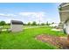 Spacious backyard includes green grass and storage shed in the distance at 605 Memorial Dr, Edinburgh, IN 46124