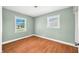 This bedroom has dual windows and wood-look flooring, providing natural light and a clean aesthetic at 605 Memorial Dr, Edinburgh, IN 46124