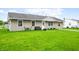 Inviting single-story home with a tidy lawn and a cozy bench near the front door at 605 Memorial Dr, Edinburgh, IN 46124