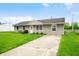 Well-maintained single-story home with a driveway and lush green lawn at 605 Memorial Dr, Edinburgh, IN 46124