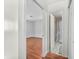 Bright hallway view leading to a bathroom with shower-tub combo and a bedroom with wood-look flooring at 605 Memorial Dr, Edinburgh, IN 46124