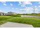 A new home community features a grassy lawn and ponds, perfect for outdoor activities at 6219 Medina Spirit Dr, Indianapolis, IN 46237