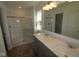 Well-lit bathroom with a double sink vanity, a large mirror, and a glass-enclosed shower, ready for customization at 6219 Medina Spirit Dr, Indianapolis, IN 46237