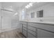 Bathroom featuring double sink vanity, quartz countertop, walk-in shower, and wood look flooring at 6219 Medina Spirit Dr, Indianapolis, IN 46237