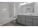 Bathroom features a double sink vanity, modern lighting, and a shower over tub combination at 6219 Medina Spirit Dr, Indianapolis, IN 46237