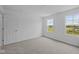 Bright bedroom with two large windows providing natural light and neutral carpet at 6219 Medina Spirit Dr, Indianapolis, IN 46237
