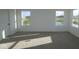 Spacious bedroom featuring plush carpeting, two large windows with scenic views, and a closet door, ready for customization at 6219 Medina Spirit Dr, Indianapolis, IN 46237