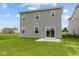 A two-story home has a well-manicured backyard with a sliding glass door that leads to the patio at 6219 Medina Spirit Dr, Indianapolis, IN 46237