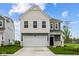 Charming two-story home with a two-car garage, black door, and nicely manicured lawn at 6219 Medina Spirit Dr, Indianapolis, IN 46237