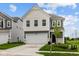 Charming two-story home with a two-car garage, black door, and nicely manicured lawn at 6219 Medina Spirit Dr, Indianapolis, IN 46237