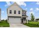 Charming two-story home with a two-car garage, black door, and nicely manicured lawn at 6219 Medina Spirit Dr, Indianapolis, IN 46237