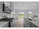Modern kitchen with stainless steel appliances, granite counters, island, and an open floorplan at 6219 Medina Spirit Dr, Indianapolis, IN 46237
