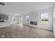 Bright living room with open floor plan, recessed lighting, fireplace and wood-look flooring at 6219 Medina Spirit Dr, Indianapolis, IN 46237