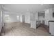 Spacious living room with open floor plan, recessed lighting and beautiful wood-look flooring at 6219 Medina Spirit Dr, Indianapolis, IN 46237