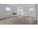 Bright living room with open floor plan, recessed lighting, fireplace and wood-look flooring at 6219 Medina Spirit Dr, Indianapolis, IN 46237