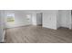 Bright living room features wood-look floors, white walls, and natural light from the double-hung windows at 6219 Medina Spirit Dr, Indianapolis, IN 46237