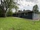 Spacious backyard featuring mature tree, gray siding and a well-maintained lawn at 7897 Moore Rd, Indianapolis, IN 46278