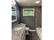 Renovated bathroom featuring a tiled shower and granite vanity at 7897 Moore Rd, Indianapolis, IN 46278