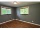 Bedroom with hardwood floors, window, and paneled walls at 7897 Moore Rd, Indianapolis, IN 46278