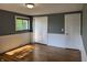 Bedroom featuring hardwood floors, closet, and window at 7897 Moore Rd, Indianapolis, IN 46278