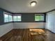 Bedroom with hardwood floors, windows, and paneled walls at 7897 Moore Rd, Indianapolis, IN 46278