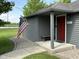 Home entrance featuring a bright red front door, bench seating and an American flag at 7897 Moore Rd, Indianapolis, IN 46278